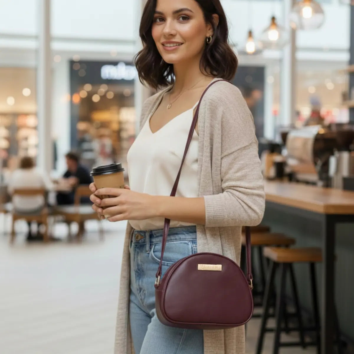 Women’s vegan leather crossbody sling bag with an adjustable strap and zippered compartments